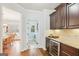 Kitchen area with counter seating, wine cooler, and views to the laundry room at 108 Turnberry Trce, Sharpsburg, GA 30277