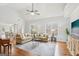 Spacious living room featuring a ceiling fan, neutral paint, and large windows at 108 Turnberry Trce, Sharpsburg, GA 30277