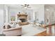 Cozy living room featuring a stone fireplace, large windows, and comfortable seating at 108 Turnberry Trce, Sharpsburg, GA 30277