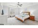 Bright main bedroom with tray ceilings, a large window, and neutral decor at 108 Turnberry Trce, Sharpsburg, GA 30277