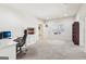 Bright home office featuring neutral walls, carpet, a desk and chair, with a view to the backyard at 108 Turnberry Trce, Sharpsburg, GA 30277