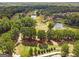 Scenic aerial view of a golf course community surrounded by lush green trees and ponds at 2019 Emerald Dr, Jonesboro, GA 30236