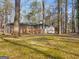Charming backyard view of a two-story home with a screened-in porch and wooded surroundings at 2019 Emerald Dr, Jonesboro, GA 30236
