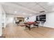 Large basement area featuring luxury vinyl floors, fireplace, pool table, tv, and comfortable seating area at 2019 Emerald Dr, Jonesboro, GA 30236