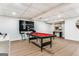 Basement featuring luxury vinyl floors, a red pool table, contemporary art and bar stools at 2019 Emerald Dr, Jonesboro, GA 30236