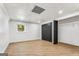 Spacious basement area with a window, closet, and light wood flooring at 2019 Emerald Dr, Jonesboro, GA 30236