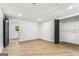 Unfinished basement area featuring luxury vinyl floors, black doors and a window with a view of surrounding trees at 2019 Emerald Dr, Jonesboro, GA 30236