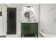 Modern bathroom with a stylish vanity, round mirror, and elegant marble tiling at 2019 Emerald Dr, Jonesboro, GA 30236