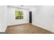 Clean and bright bedroom with a large window and a black door at 2019 Emerald Dr, Jonesboro, GA 30236