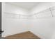 Walk-in closet featuring white walls, wood floors, and wire shelving for optimal organization at 2019 Emerald Dr, Jonesboro, GA 30236