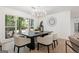 Bright dining room featuring modern chandelier, large window with backyard view, and stylish decor at 2019 Emerald Dr, Jonesboro, GA 30236