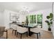 Bright dining room featuring modern chandelier, large window with backyard view, and stylish decor at 2019 Emerald Dr, Jonesboro, GA 30236