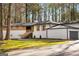 Charming front exterior with a driveway and well-maintained lawn, enveloped by mature trees at 2019 Emerald Dr, Jonesboro, GA 30236