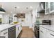 Well-lit kitchen with white cabinetry, stainless steel appliances, and a modern aesthetic at 2019 Emerald Dr, Jonesboro, GA 30236