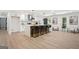 Modern kitchen with a waterfall island, black fixtures, and sleek cabinetry at 2019 Emerald Dr, Jonesboro, GA 30236