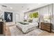 Bright main bedroom featuring a large window, accent wall, and a luxurious king-size bed at 2019 Emerald Dr, Jonesboro, GA 30236