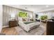 Spacious main bedroom featuring a large window, accent wall, and a luxurious king-size bed at 2019 Emerald Dr, Jonesboro, GA 30236