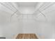 Empty walk-in closet with shelving and a clean, minimalist design, ready for customization at 2019 Emerald Dr, Jonesboro, GA 30236