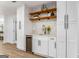 Elegant wet bar area with custom cabinetry, wine storage, and stylish backsplash at 2019 Emerald Dr, Jonesboro, GA 30236