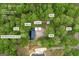 Aerial view of the property, showcasing the home, carport, shop, barn, and pond at 7616 Nicholson Rd, Cumming, GA 30028