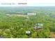 Birds eye view of a residence situated amongst a dense forest and a quiet road at 7616 Nicholson Rd, Cumming, GA 30028