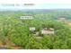 Overhead perspective of a home with wooded surroundings, identified by street and town names at 7616 Nicholson Rd, Cumming, GA 30028