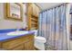 Charming bathroom featuring a blue countertop sink, toilet, and built-in shelving for added functionality and character at 7616 Nicholson Rd, Cumming, GA 30028