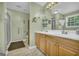 Functional bathroom featuring a double sink vanity and walk-in shower offering convenience and accessibility at 7616 Nicholson Rd, Cumming, GA 30028
