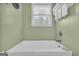 Bright bathroom features a bathtub with neutral tones, providing a relaxing and accessible space at 7616 Nicholson Rd, Cumming, GA 30028