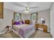 Inviting bedroom featuring a ceiling fan and dresser, offering comfort and functionality in a serene setting at 7616 Nicholson Rd, Cumming, GA 30028