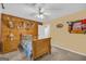 Unique bedroom featuring wood-paneled walls, and a wall-mounted deer collection, creating a rustic and personalized space at 7616 Nicholson Rd, Cumming, GA 30028
