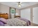 Comfortable bedroom with plush bedding, light-filled window, and ample closet space at 7616 Nicholson Rd, Cumming, GA 30028