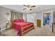 Cozy bedroom with plush carpet, ceiling fan, and access to a walk-in closet at 7616 Nicholson Rd, Cumming, GA 30028