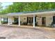 Inviting covered porch with seating, ceiling fans, and decorative elements at 7616 Nicholson Rd, Cumming, GA 30028