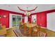 Charming dining room with a view to the backyard, chandelier, and wood table at 7616 Nicholson Rd, Cumming, GA 30028