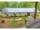 Rear exterior view of a home with sliding glass door onto the patio and an aging roof in the foreground at 7616 Nicholson Rd, Cumming, GA 30028