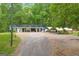 Charming home with covered porch, carport, and a gravel driveway at 7616 Nicholson Rd, Cumming, GA 30028