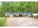 Charming single-story home featuring a metal roof, covered porch, and ample parking at 7616 Nicholson Rd, Cumming, GA 30028