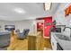 Open kitchen with modern appliances, granite countertops, and an adjacent living area at 7616 Nicholson Rd, Cumming, GA 30028