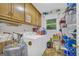 Well-equipped laundry room with washer, dryer, cabinets, and ample storage space to simplify household tasks at 7616 Nicholson Rd, Cumming, GA 30028