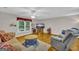 Comfortable living room featuring hardwood floors, a ceiling fan, and lots of natural light at 7616 Nicholson Rd, Cumming, GA 30028