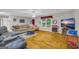 Bright living room with hardwood floors, cozy seating, and a large window at 7616 Nicholson Rd, Cumming, GA 30028