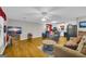 Spacious living room with hardwood floors, ceiling fan, and comfortable recliners at 7616 Nicholson Rd, Cumming, GA 30028