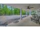 Spacious covered porch featuring comfortable seating and picturesque wooded views at 7616 Nicholson Rd, Cumming, GA 30028