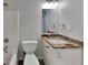 Bathroom featuring a vanity with a granite countertop and a shower-tub combo at 321 Shadowbrooke Dr, Loganville, GA 30052