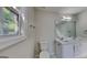 Bathroom featuring a double vanity, and toilet next to a window with natural light at 321 Shadowbrooke Dr, Loganville, GA 30052