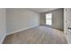 Bright, carpeted bedroom with a large window and neutral paint at 321 Shadowbrooke Dr, Loganville, GA 30052