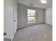 Cozy bedroom features carpet flooring and a window offering natural light at 321 Shadowbrooke Dr, Loganville, GA 30052