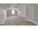 Carpeted bonus room with natural light from a single window and white door at 321 Shadowbrooke Dr, Loganville, GA 30052
