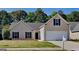 Charming single-Gathering home features a two-car garage and well-maintained lawn at 321 Shadowbrooke Dr, Loganville, GA 30052